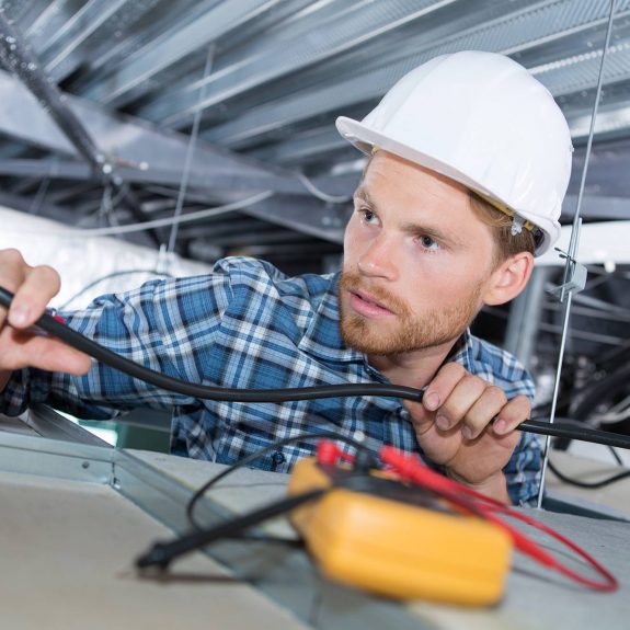 Electrician Running Wires In Suspended Ceiling